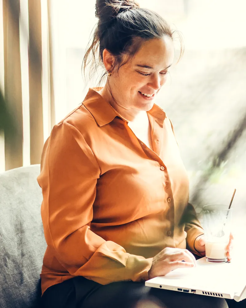 Magento webshop laten maken bij SjopSjop Molina van SjopSjop werkt geconcentreerd op haar laptop aan een Magento 2 webshop